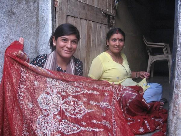 Neighbors hand-beading saris, Junagadh