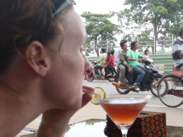 Me with cocktail watching Phnom Penh traffic