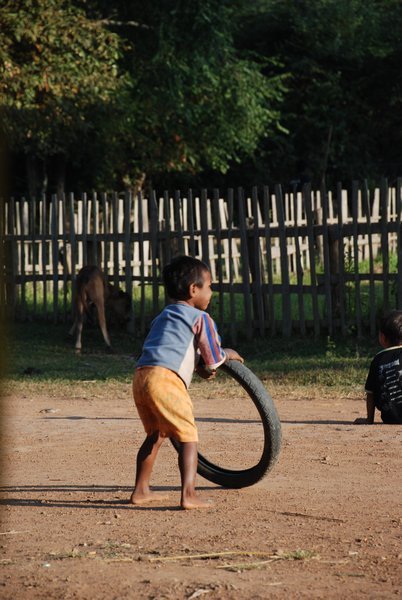 Local Boy Playing With the Good Old Wheel