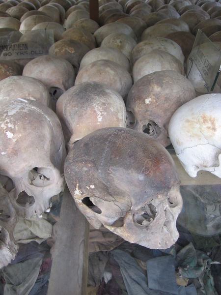 Silencing. Notice the clothes of the victims under the skulls. 