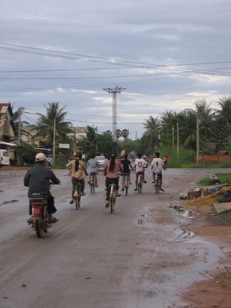 Teenaged biker gangs hanging out on the streets of Kampot after school