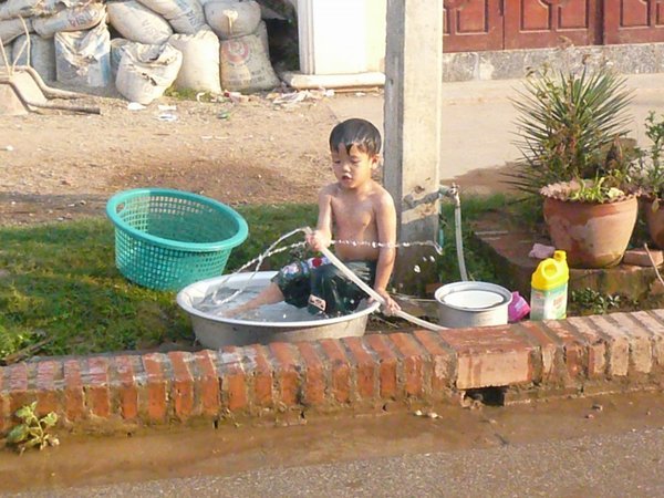 Boy playing in a pan of water