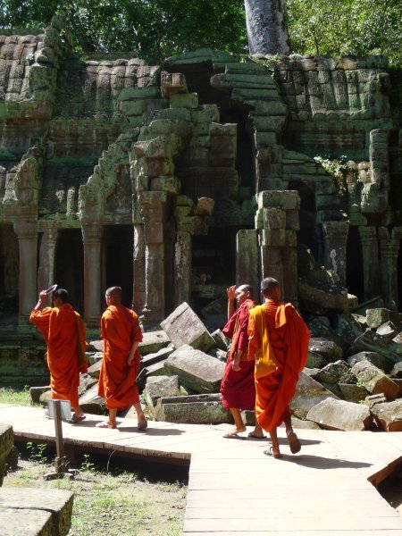 monks making their way through Ta Phrom