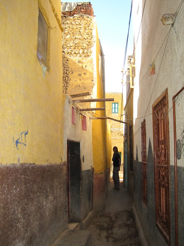 Ivan walking through the narrow streets of the Nubian village