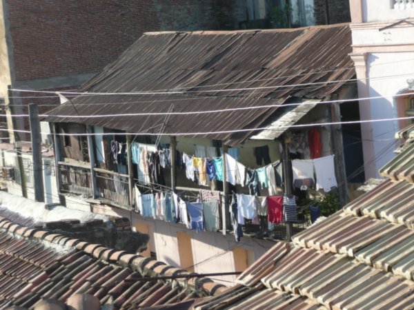 clothes hanging from balcony over rooftops