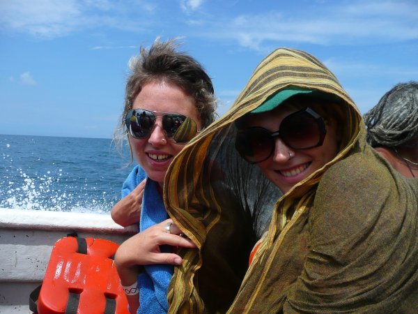 Laura and Erin trying to stay dry and not get burned by the sun on the boat ride back to Taganga.