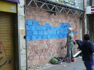 An urban artist and his brick wall canvas
