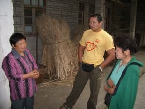 Talking to a villager about the damage to her house