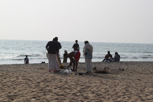 locals doing a puja on the sacred beach