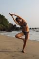 Nina doing yoga on the beach