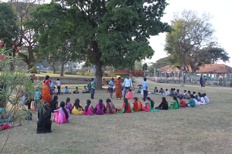 a school class having dinner in the temple garden in Halebid