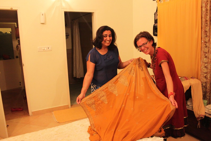 Yamini and Nina checking out the shopping items (here a new sari) late at night