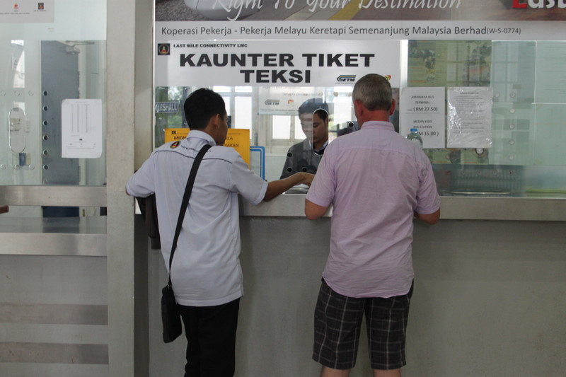 getting a ticket for a teksi at the kaunter