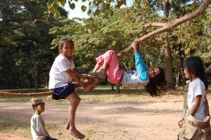 kids swinging on a tree near Angkor Wat