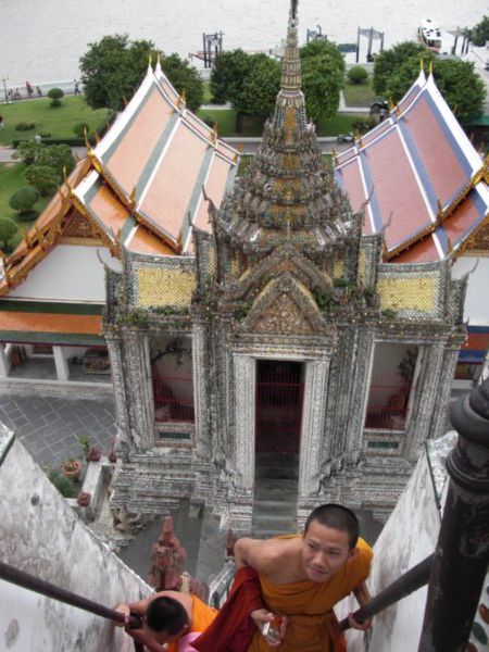Buddhist monks making their way up Wat Arun