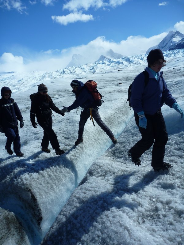 The group making its way over cracks in the ice