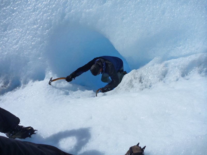 Our guide picking down a hole in the ice