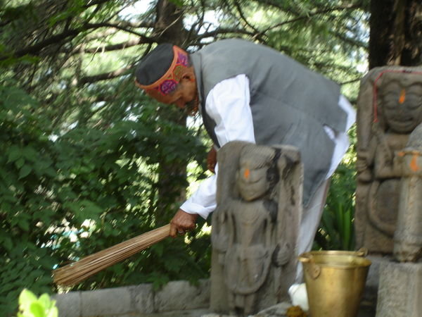 Man sweeping around the shrine