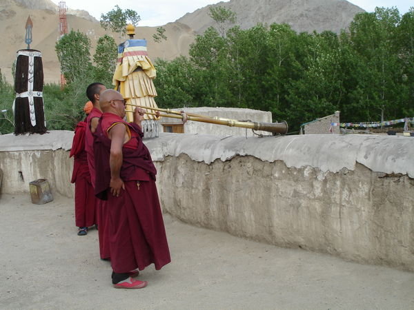 Monks blowing horns at Sankar Gompa
