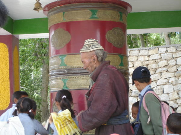 Locals turning large Prayer Wheel at Likir Monastery