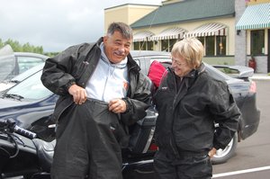Pastor Roger shows us how to put on rain gear.  He's serious about this as Edie watches.