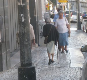One of the countless nmber of people getting around with walking sticks