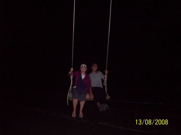 On a swing, with a headlamp on
