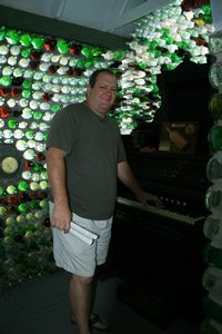 Tim playing the organ inside the bottle house
