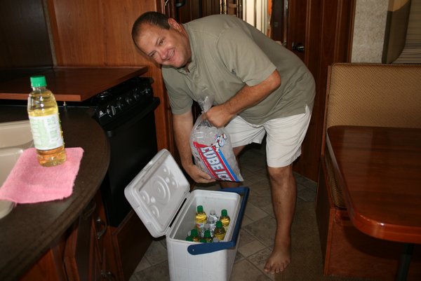 Tim filling up the cooler with ice and drinks.