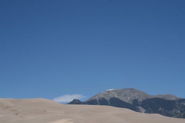 The beautiful sand dunes with snow capped mountains in the background.