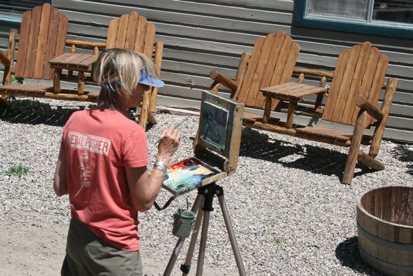 An artist working on a painting on the streets of Crested Butte, CO.