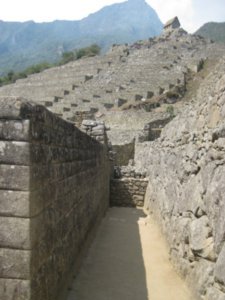 125. Inca Wall at Machu Picchu with terraces and guardhouse in backround