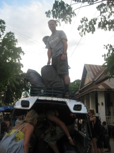 27. Loading bags up on to the roof of the Sawngthaew when we arrive in Luang Prabang