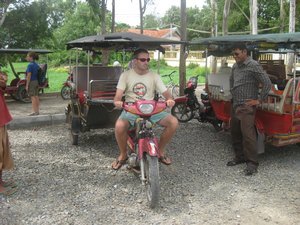 51. Mike driving Neng's moto outside Cheung Ek Killing Fields near Phnom Penh