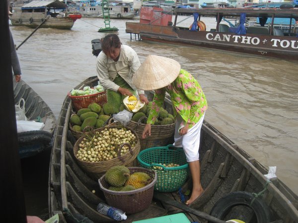 20. Trying to peel open a durian at Cai Rang floating market, Mekong Delta