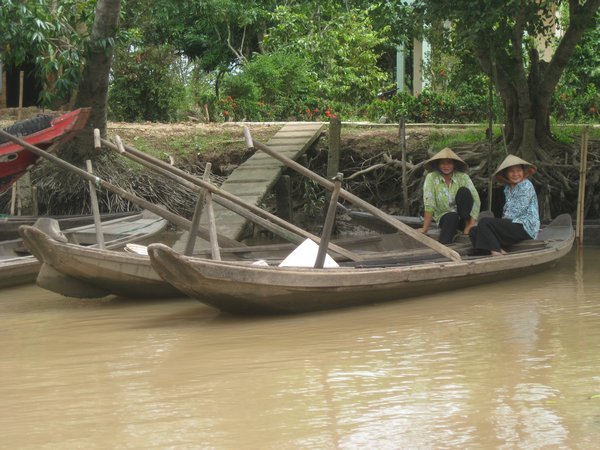 8. Two Vietnamese women in rowing boats on the Mekong Delta