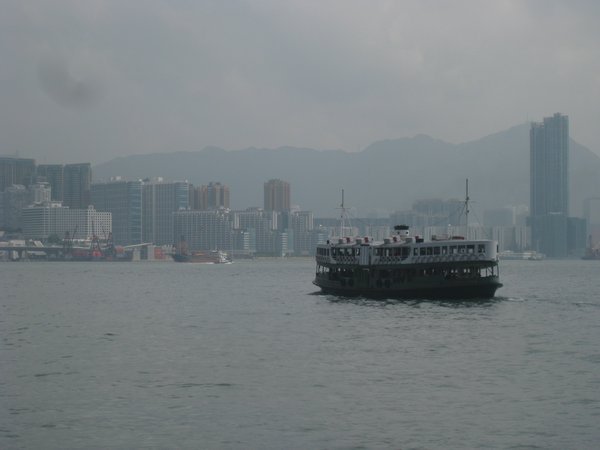 7. The Star Ferry crossing Hong Kong Harbour with Kowloon  in the background