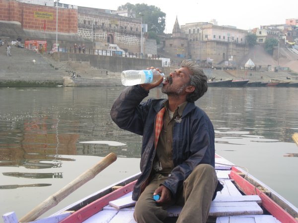 22. A braver man than me....our boatman drinks the holy waters of the Ganges, Varanasi