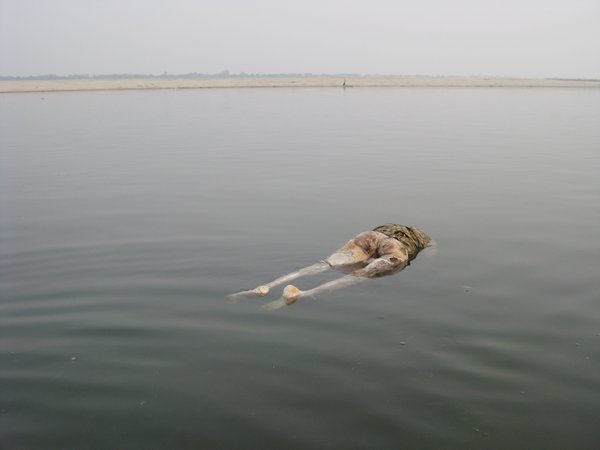 26. A dead body floats down the Ganges, Varanasi
