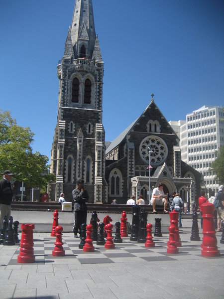 Men playing chess in front of the cathedral