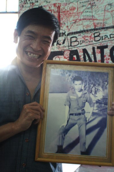 The owner with a picture of him in the War as a young man