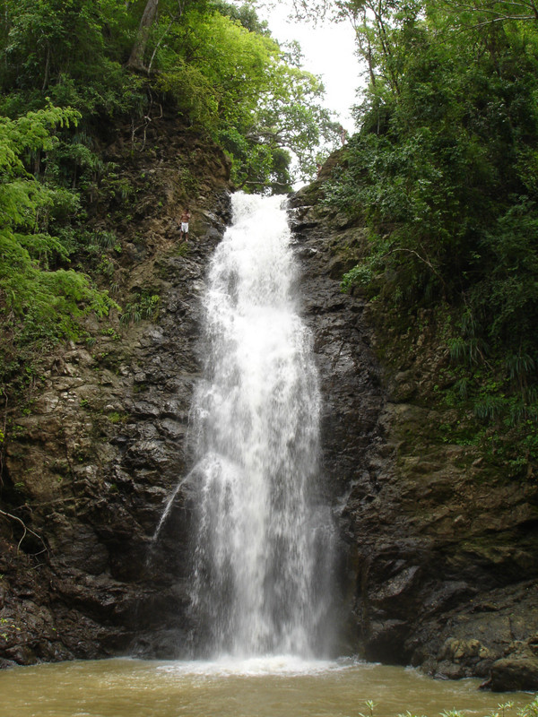 boy climbing waterfall