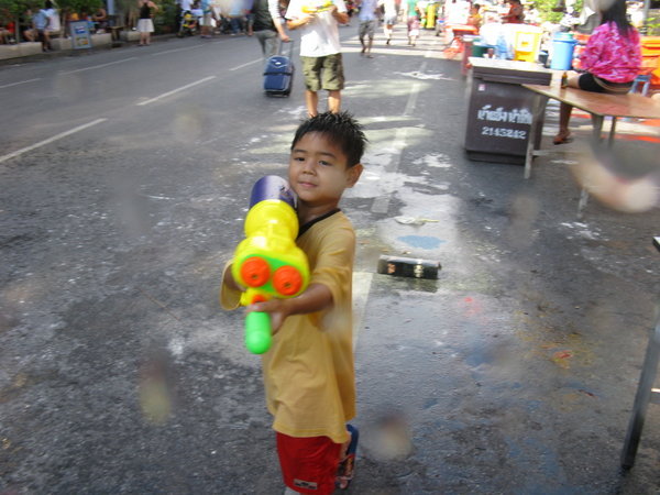 This kid's water gun is bigger than he is!