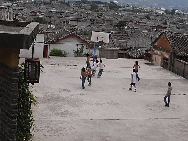 boys playing basketball with modern hair styles