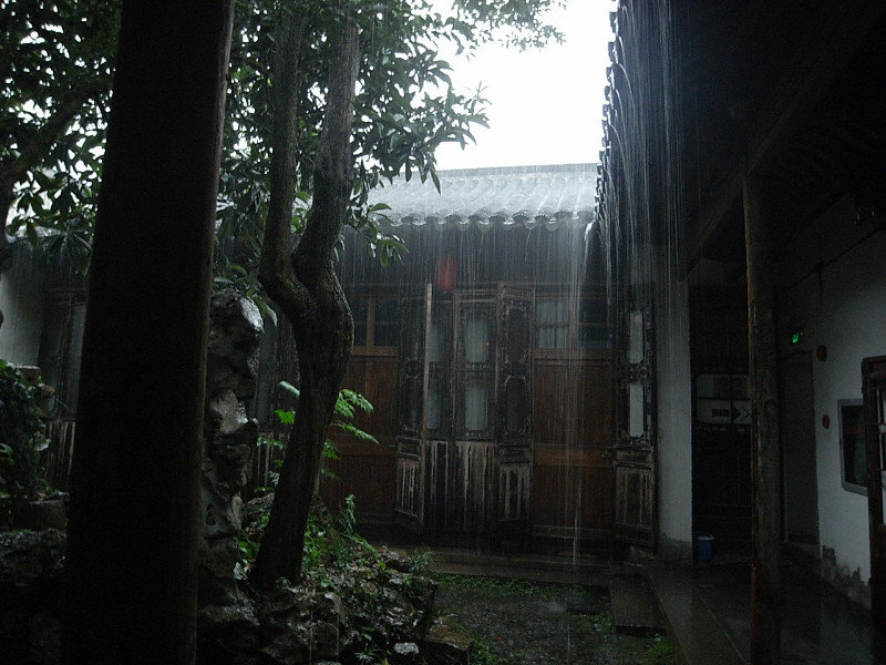 rain pouring from the clay tiles