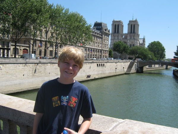 Me standing in front of the River Seine and Notre Dame