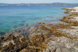 The bright blue color of the water contrasted the orange-ish color of the coastal rocks