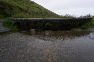 The bridge (Slea Head Drive) where the water flows over the street instead of underneath it.