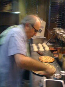 Cranky man making pizza