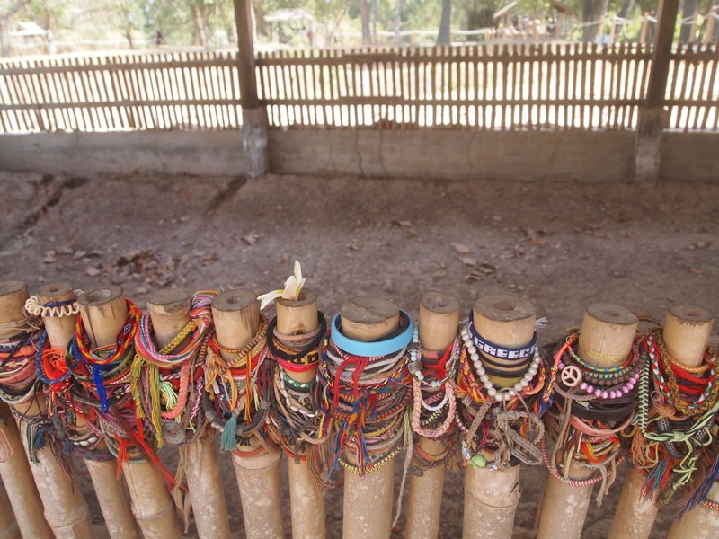 Bracelets in Front of a Mass Grave